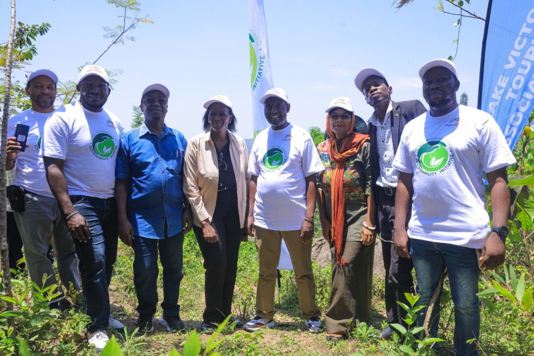 PS for Tourism John Ololtua (center) Poses for a photo with tourism players after Tree palnting exercise at Kajulu frest dueing the One Tourist One Tree camapaign activation