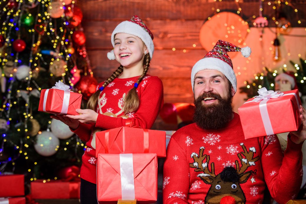 We love Boxing day. Happy family celebrate Boxing day. Bearded father man and little girl child holding present boxes on boxing day. Boxing Day is a holiday celebrated after Christmas